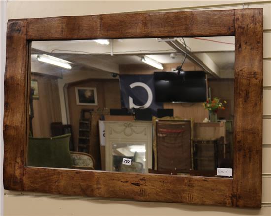 An oak framed wall mirror, W.100cm